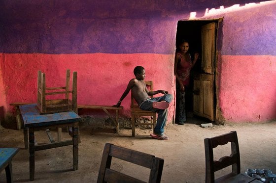 A boy sits on a chair, Omo Valley, Ethiopia, 2013